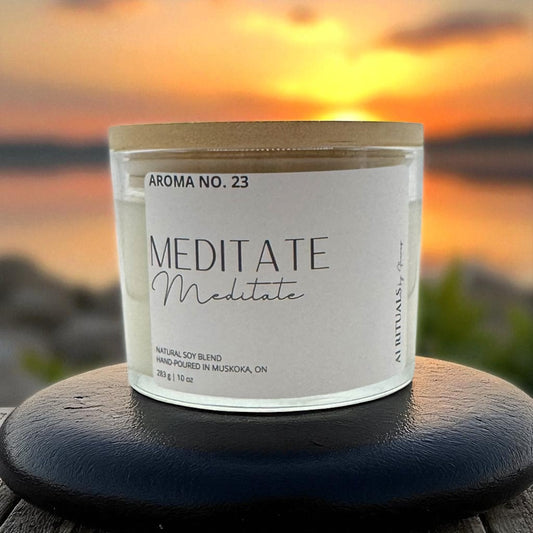 Candle labeled 'Meditate' with a sunset background